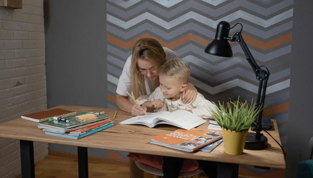 parent and child looking at a book