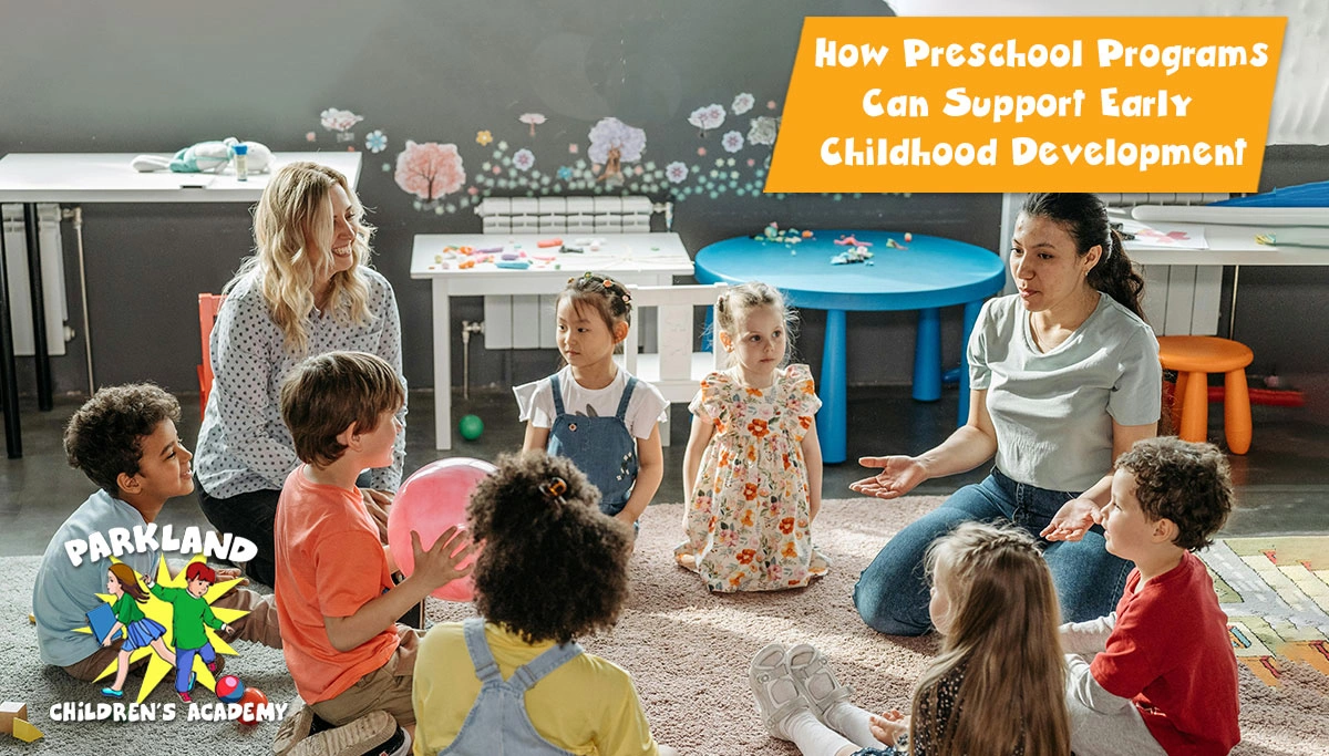 female teachers sit in a circle with preschool kids